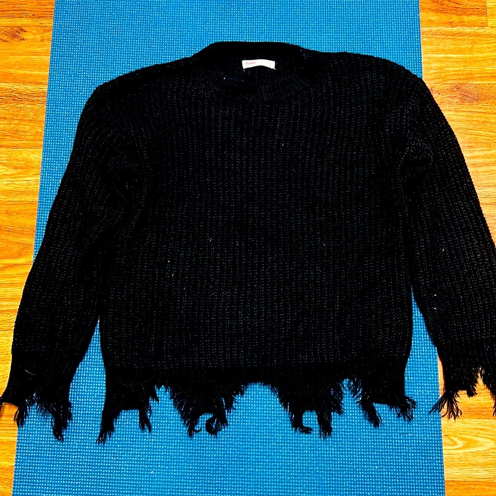 Small black knitted sweater with fringed edges